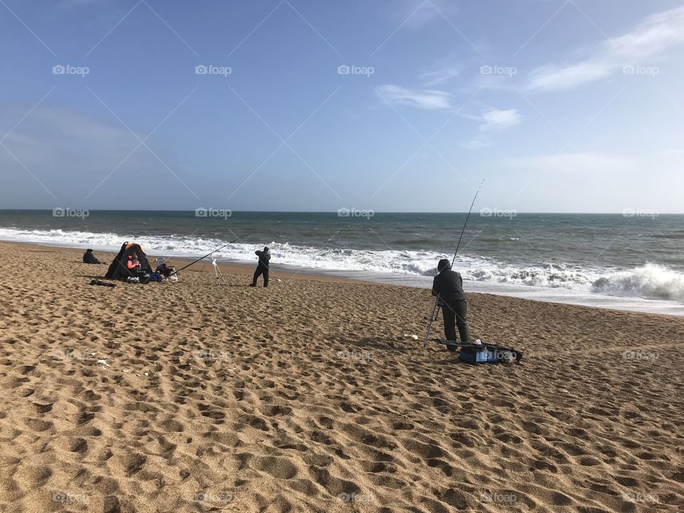 Fishing in crispy cold spring sunshine, with a bedrock of golden sands, a fisherman’s’ paradise.