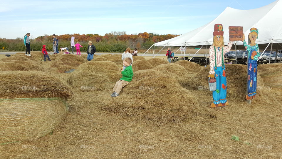 people enjoying fall. hay bale fun
