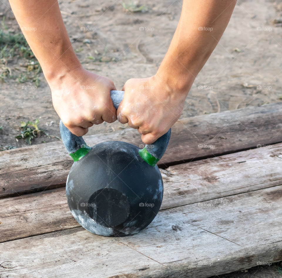 Strong hands grabbed the kettlebell.