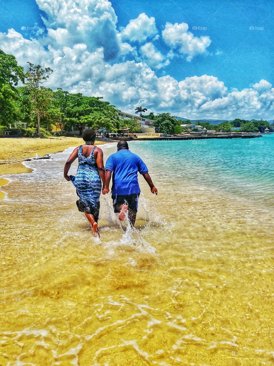 Couple Holding hands Running on the Beach