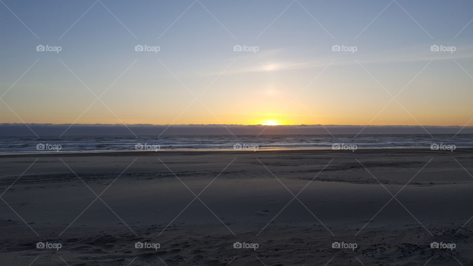 The Oregon Sandy beach during a sunset.