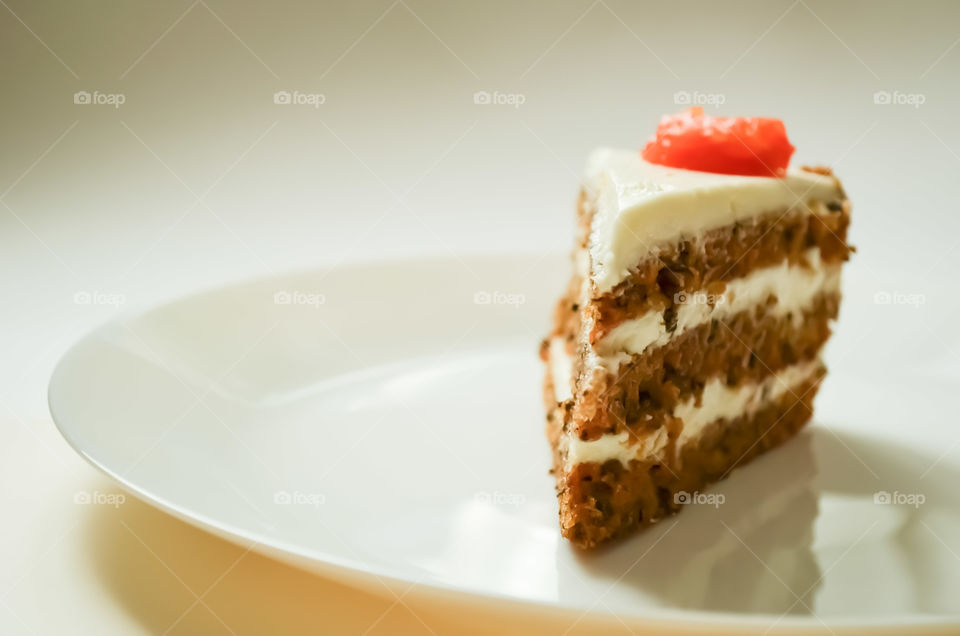 A piece of cake on the white plate. Close up.