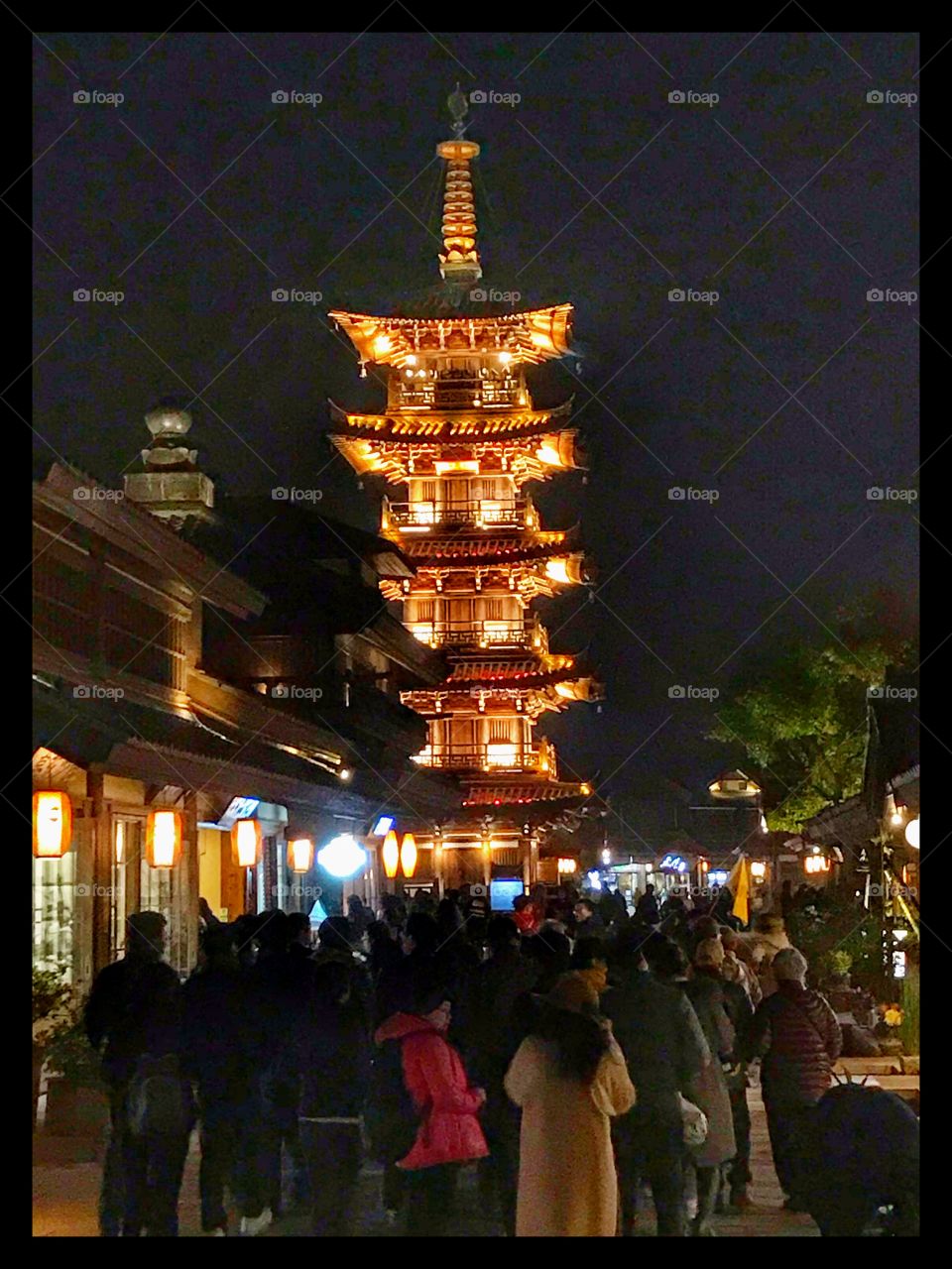 A night glimpse of a pagoda in the city of Wuxi, china - the crowd going for a performance