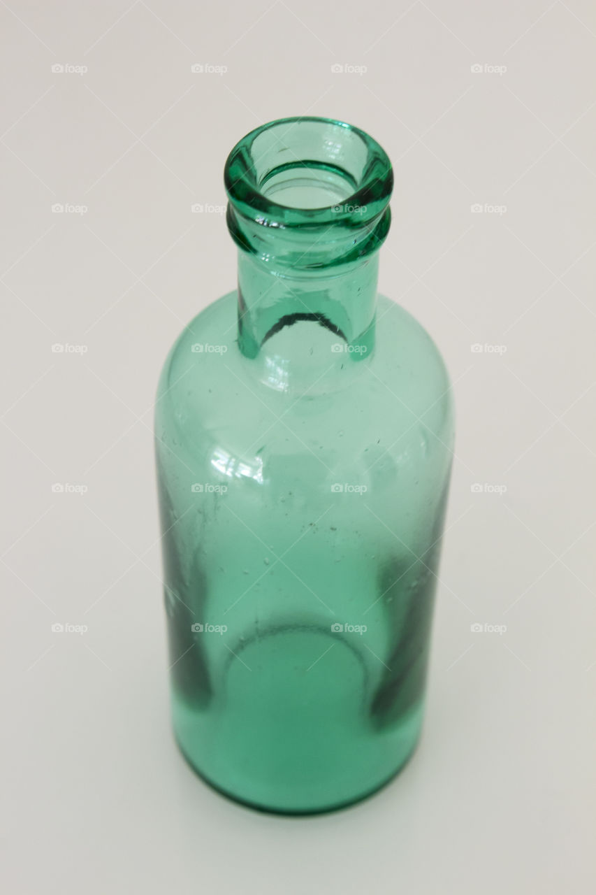 Green glass bottle white background 