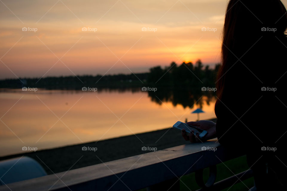 Silhouette of girl enjoing sunset