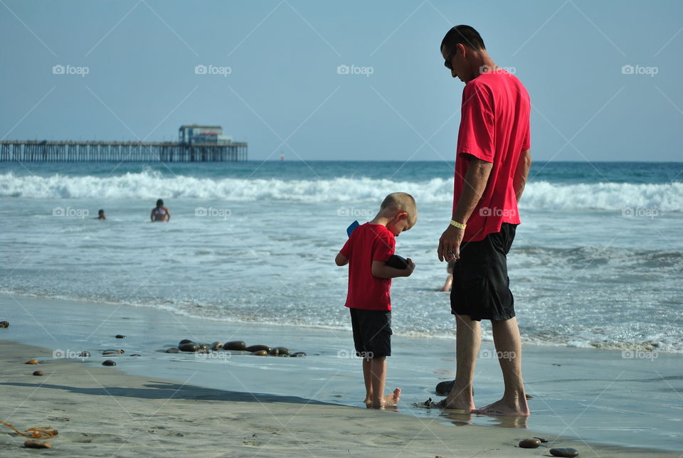 Father and son beach bonding