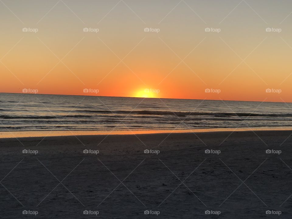Orange sun over the beach 