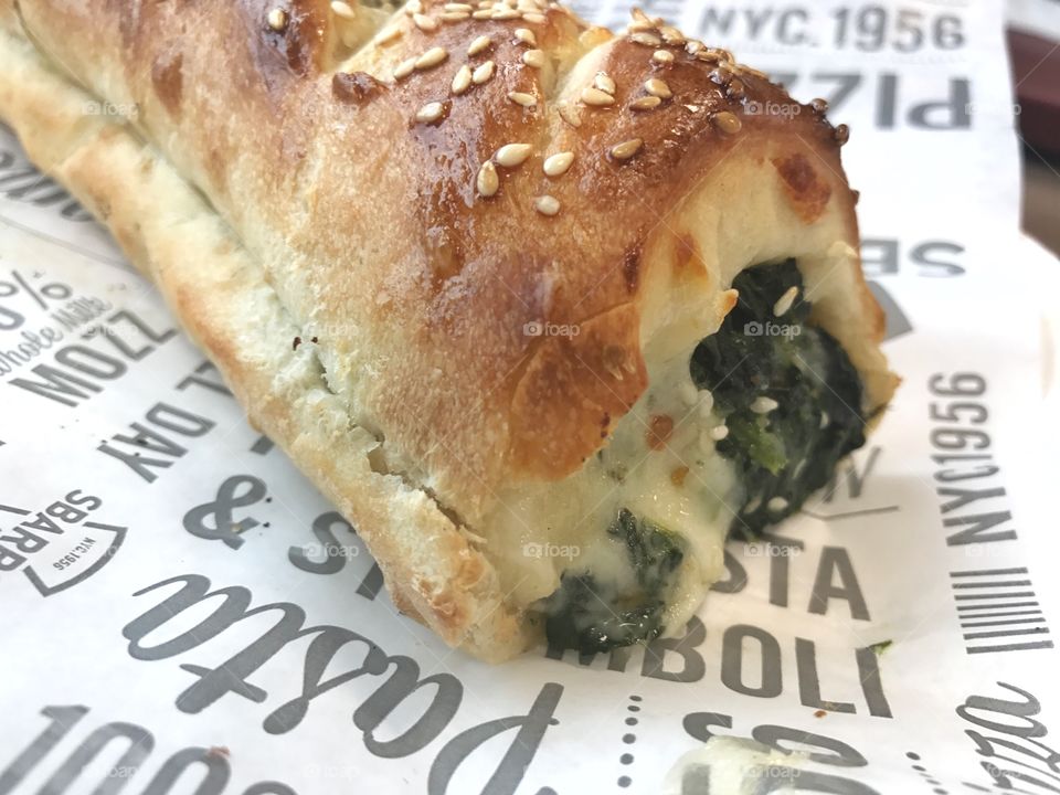 Spinach Stromboli on white wrapper