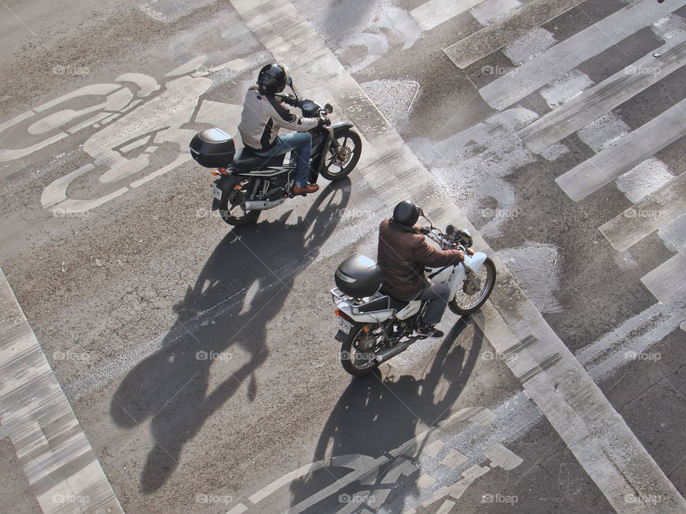 View from above of two men riding motorcycles on the street in Mexico City, Mexico