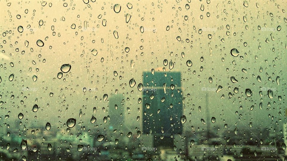 Raindrops on window. This photo was shoot on rainy day during working at office desk.