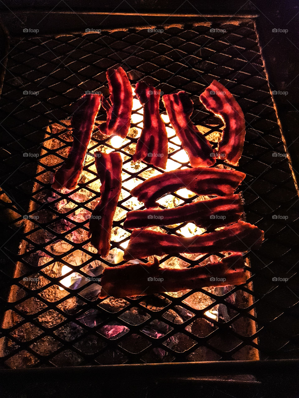 cooking meat on fire in the dark