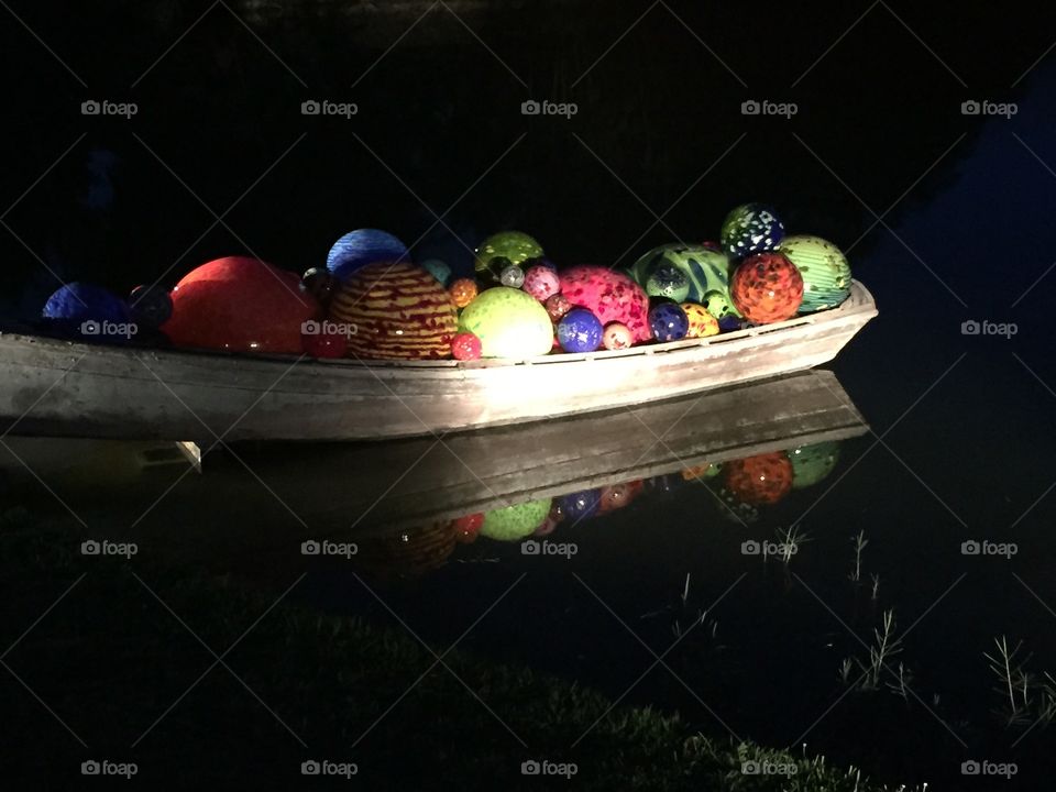 Glass bubbles in boat at night . Fairchild tropical gardens night time exhibition  