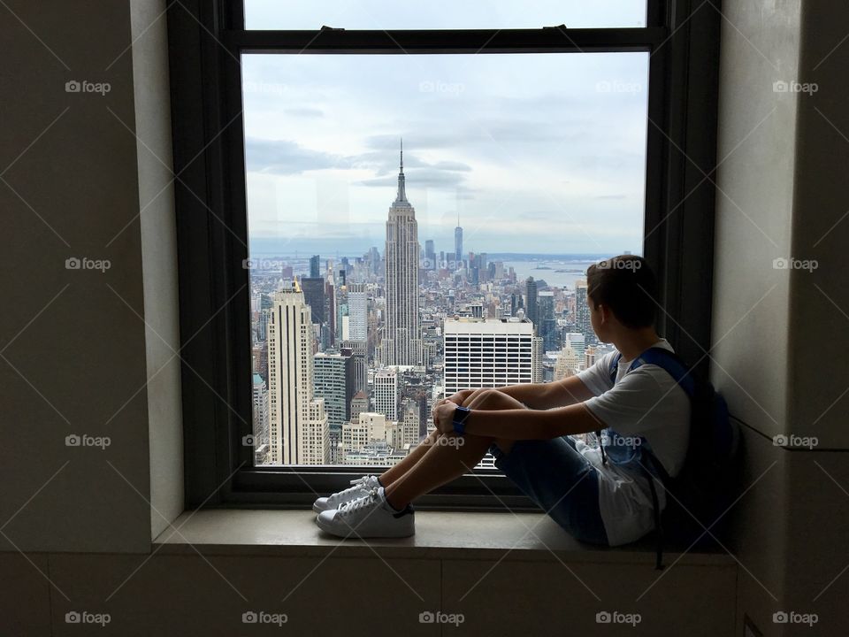 Sitting in front of a window in New York City 