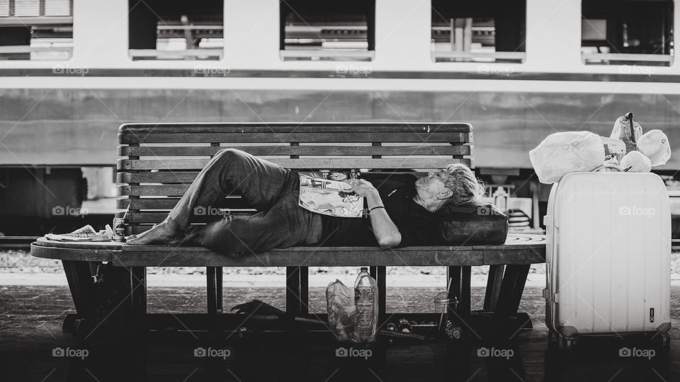 Sleeping passenger at Hua Lumphong Train Station in Bangkok Thailand