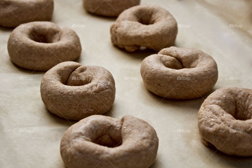 Low-angle view  of sourdough spelt and whole wheat dough for bagels on parchment paper