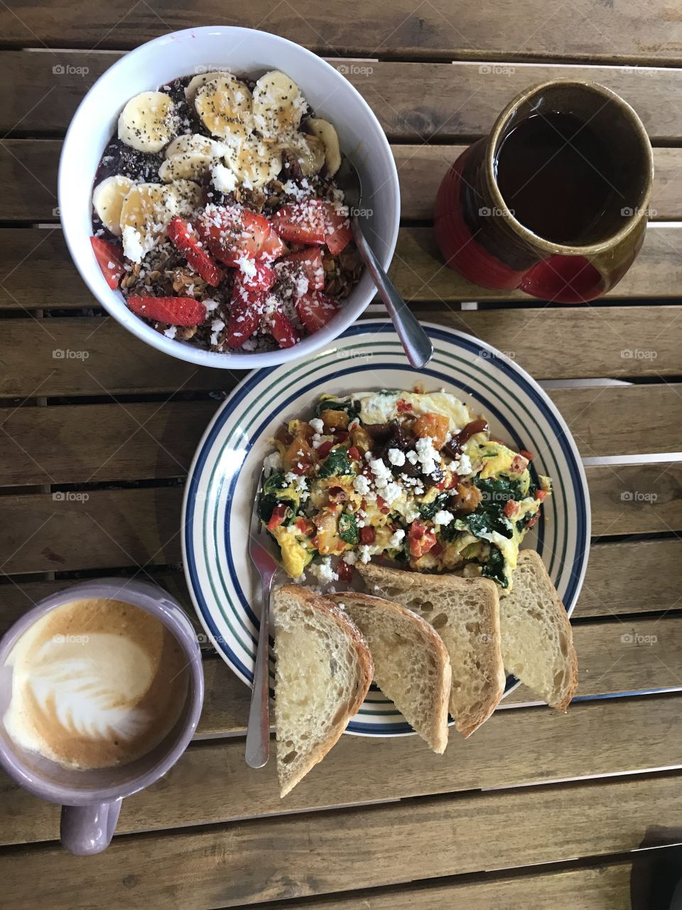 Brightly colored brunch on a wooden slat table 