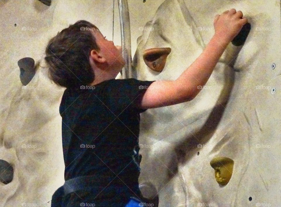 Boy Climbing Rock Wall