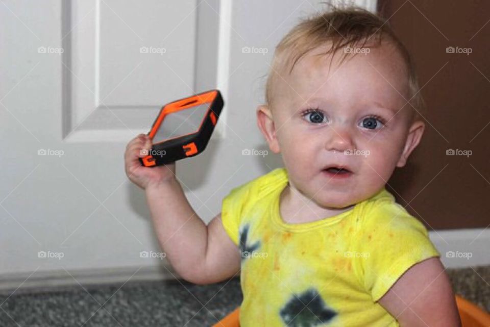 Little girl holding mobile phone