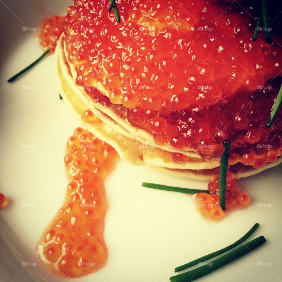 A bite of luxury-2. A closeup shot of pancakes served with red caviar