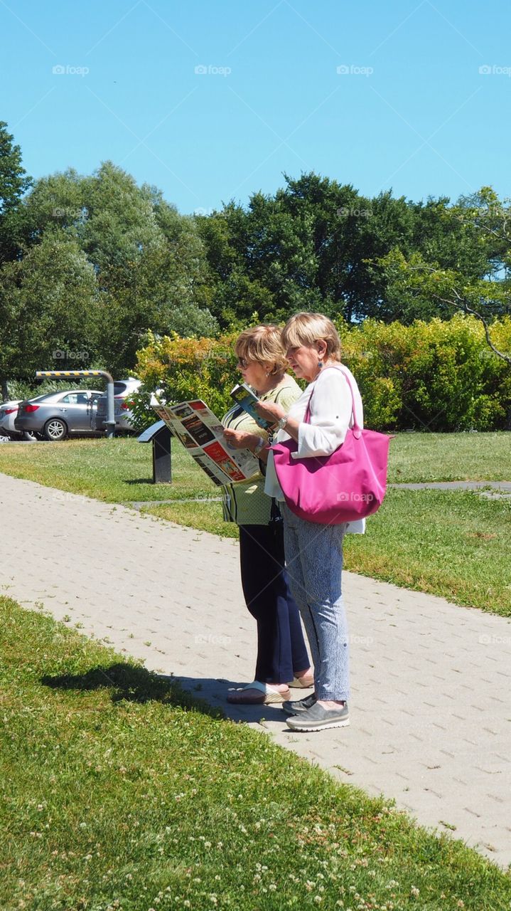 Senior tourists grandmas with maps