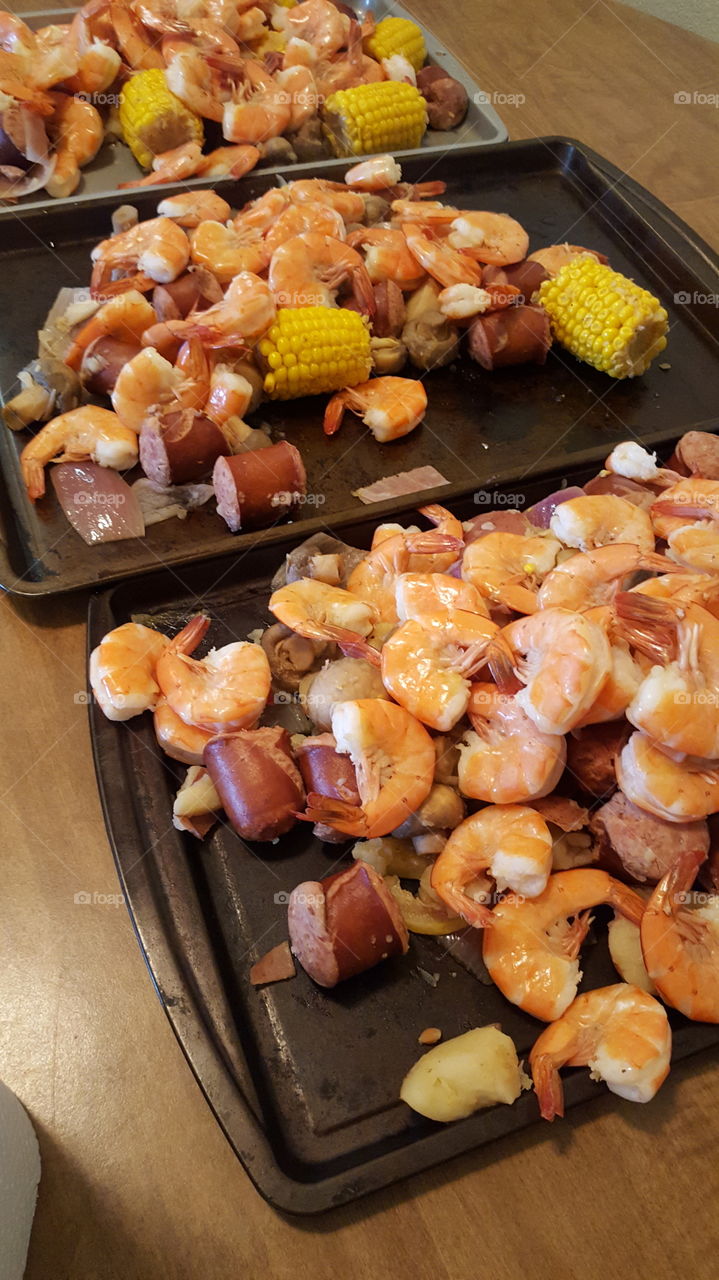 Cajun shrimp boil with sausage, corn and mushrooms.