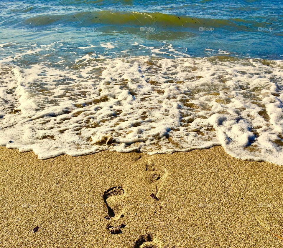 Footprints on beach sand