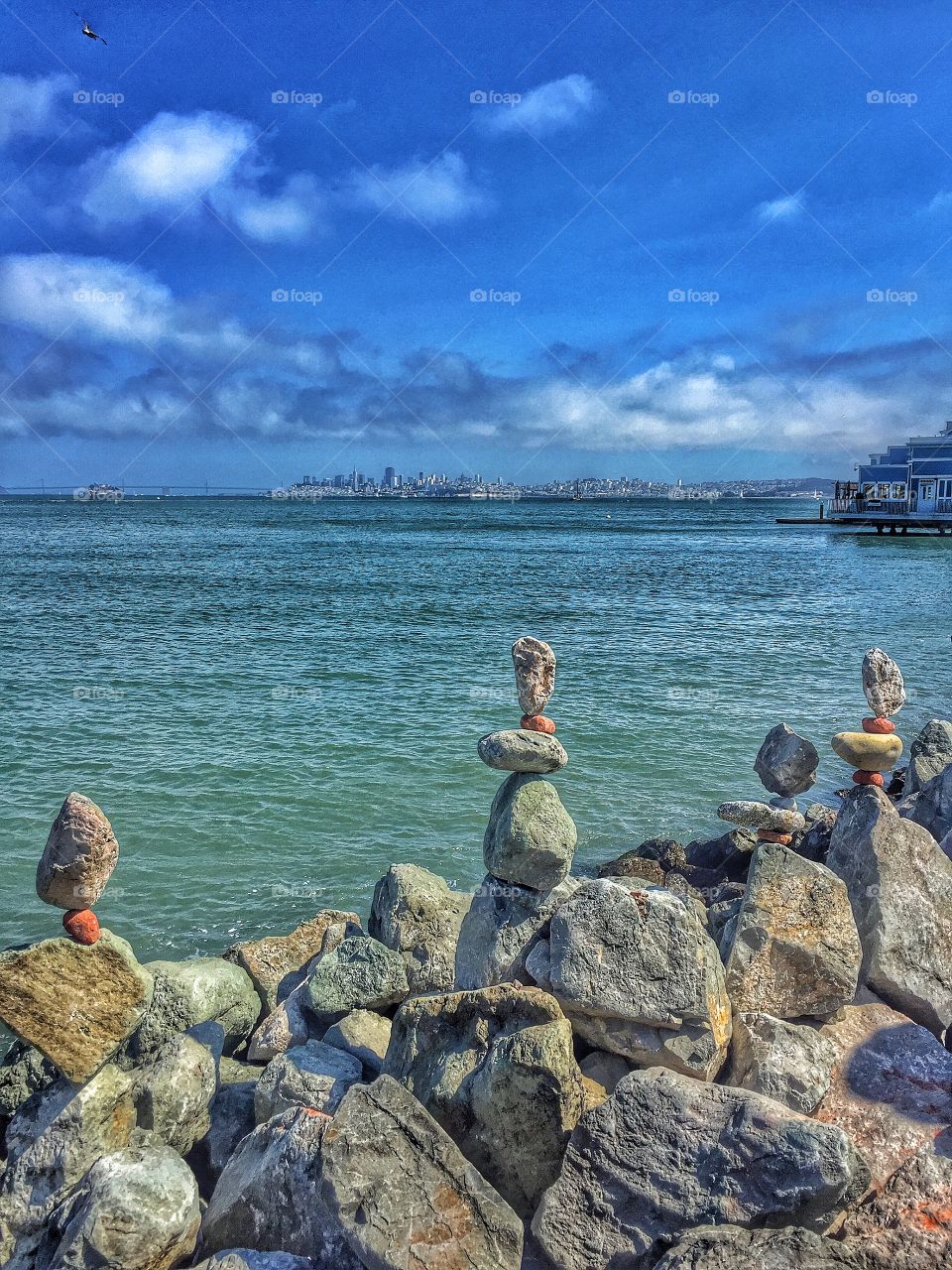 Balancing act . Street artist in Sausalito with San Francisco in the background 