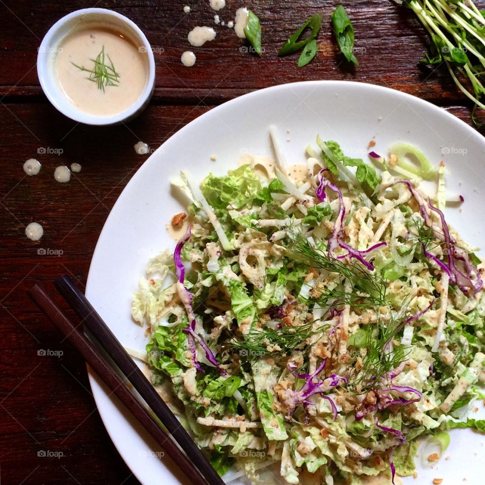 Spicy fennel salad with purple cabbage, romaine lettuce, red onion and fresh dill with creamy dressing on the side. 