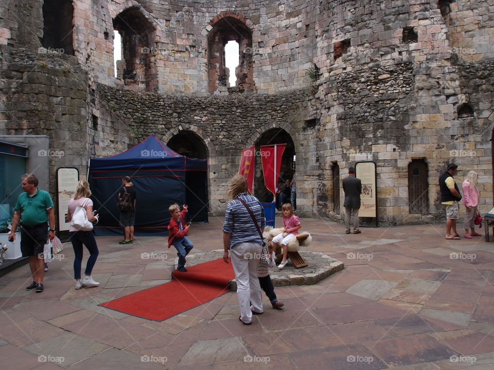 Summer vacationers enjoy Clifford’s Tower in York, England 