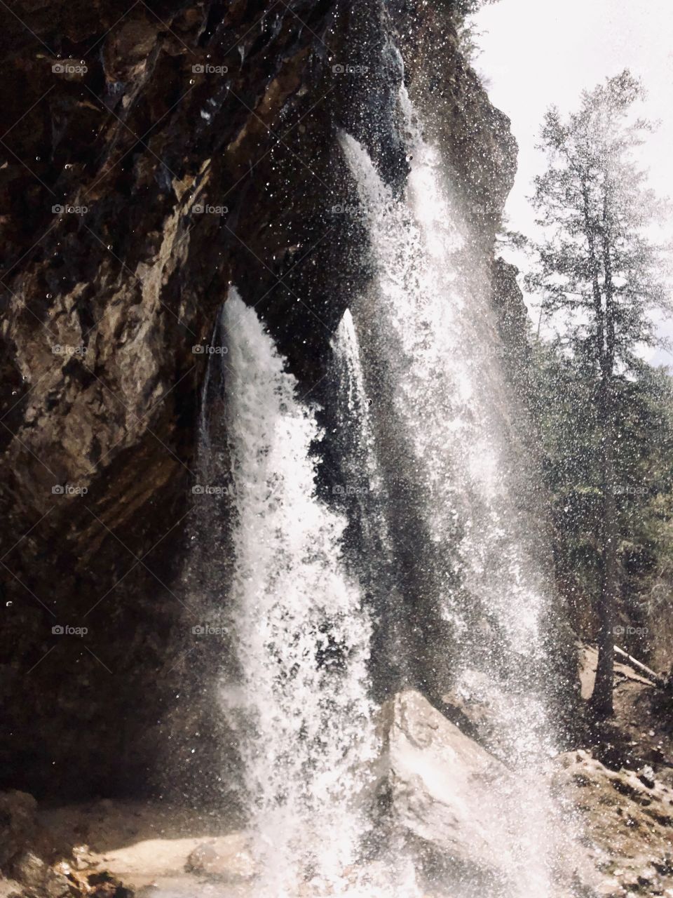 Beautiful, strong Colorado waterfall that comes flowing straight from the rocks rather than over a ledge. 