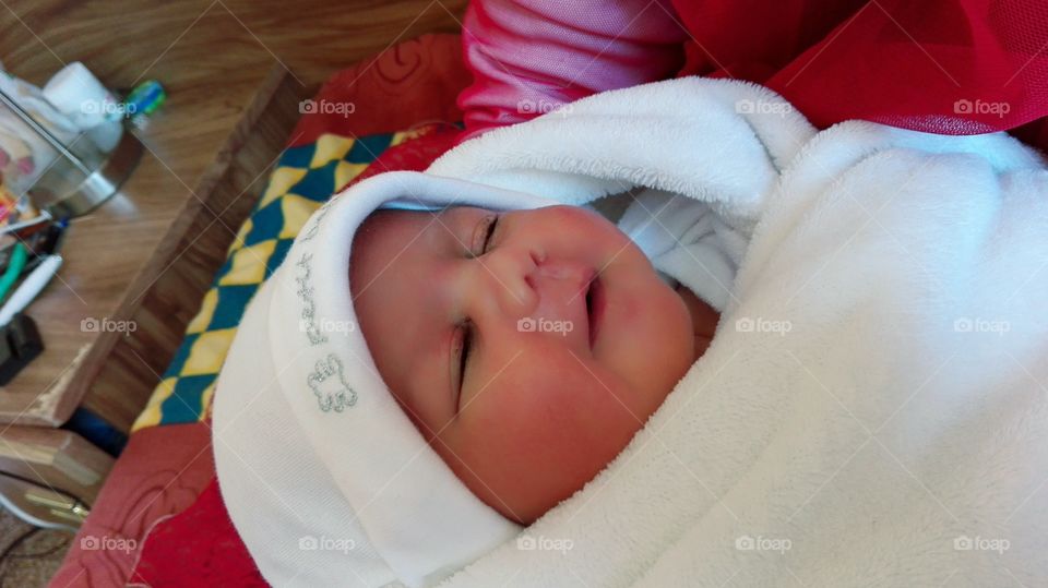 newborn baby smiling