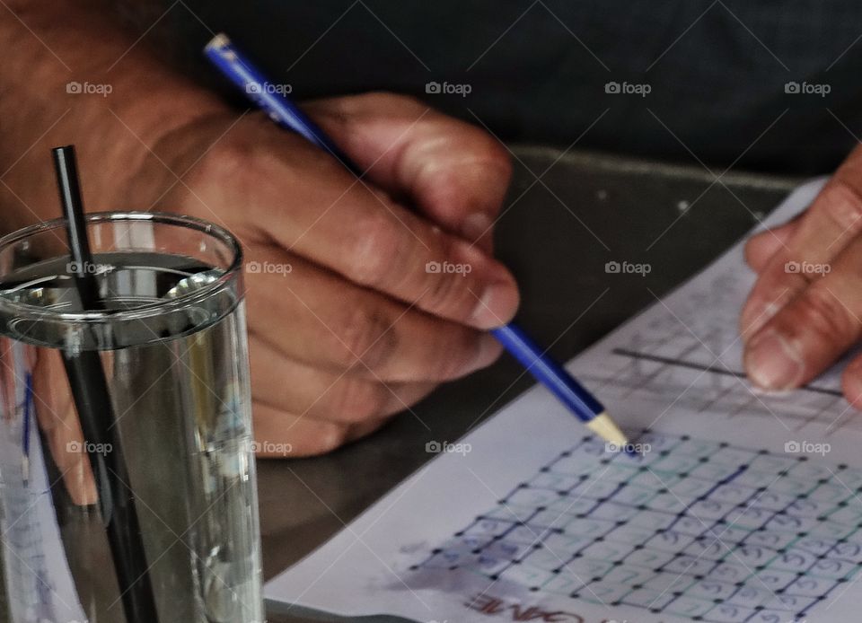 Hand Holding A Pencil. Hand With Pencil Checking Boxes On Paper
