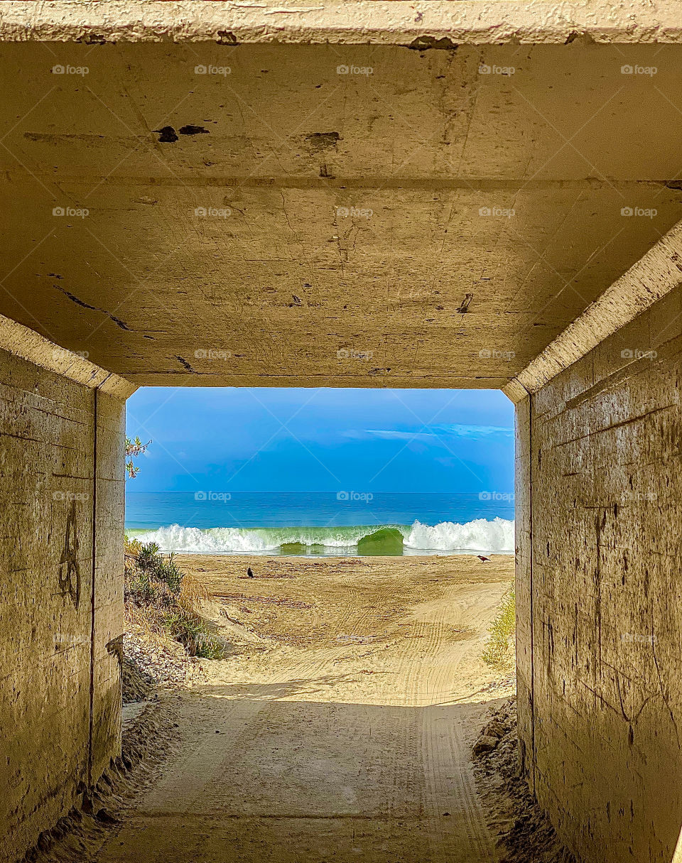 Foap Mission Moments Freezed In Photos! Catching A Crashing Wave In the Unique Moment Through A Beach Tunnel!