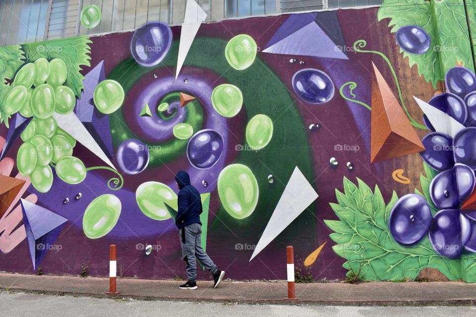 Men passes near wallart