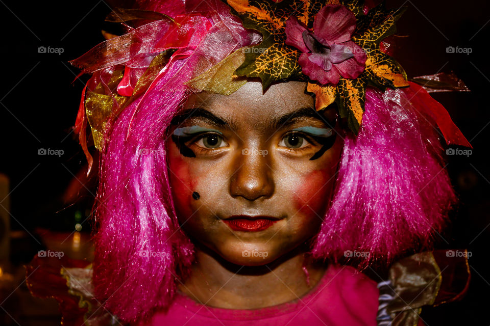 Clash of Colours: A spirited forest fairy with bright pink hair & a crown of autumn leaves, spring flowers & pink ribbon made with spun spider silk dyed with summer berries. Her golden skin shines with magic fairy dust & her eyes reflect the sky. ๐ง๐ผโโ๏ธ