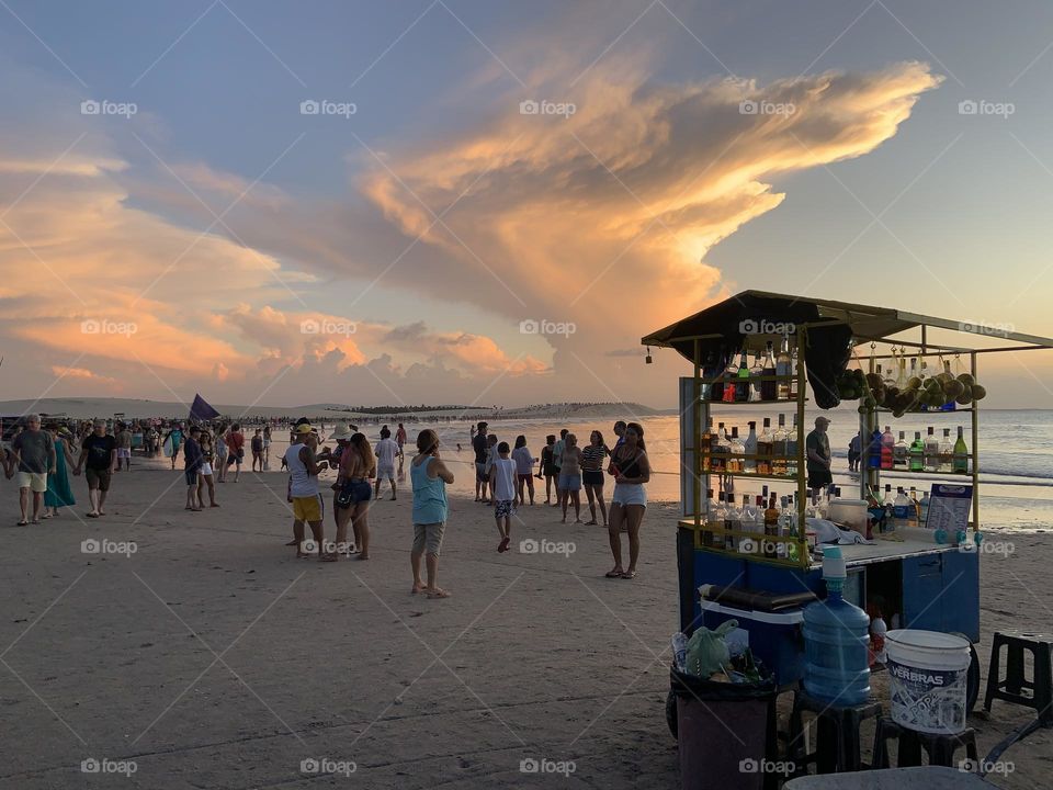 People in the beach at sunset 