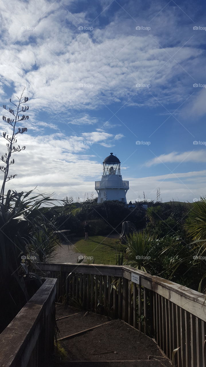 Lighthouse in New Zealand. Blue sky.