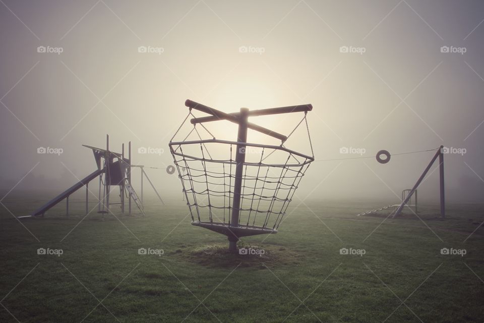 Deserted Children's Playground. A deserted children's playground on a cold foggy morning.