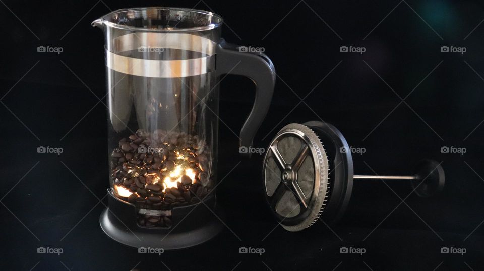 Coffee beans light up the day from inside out inside French Press