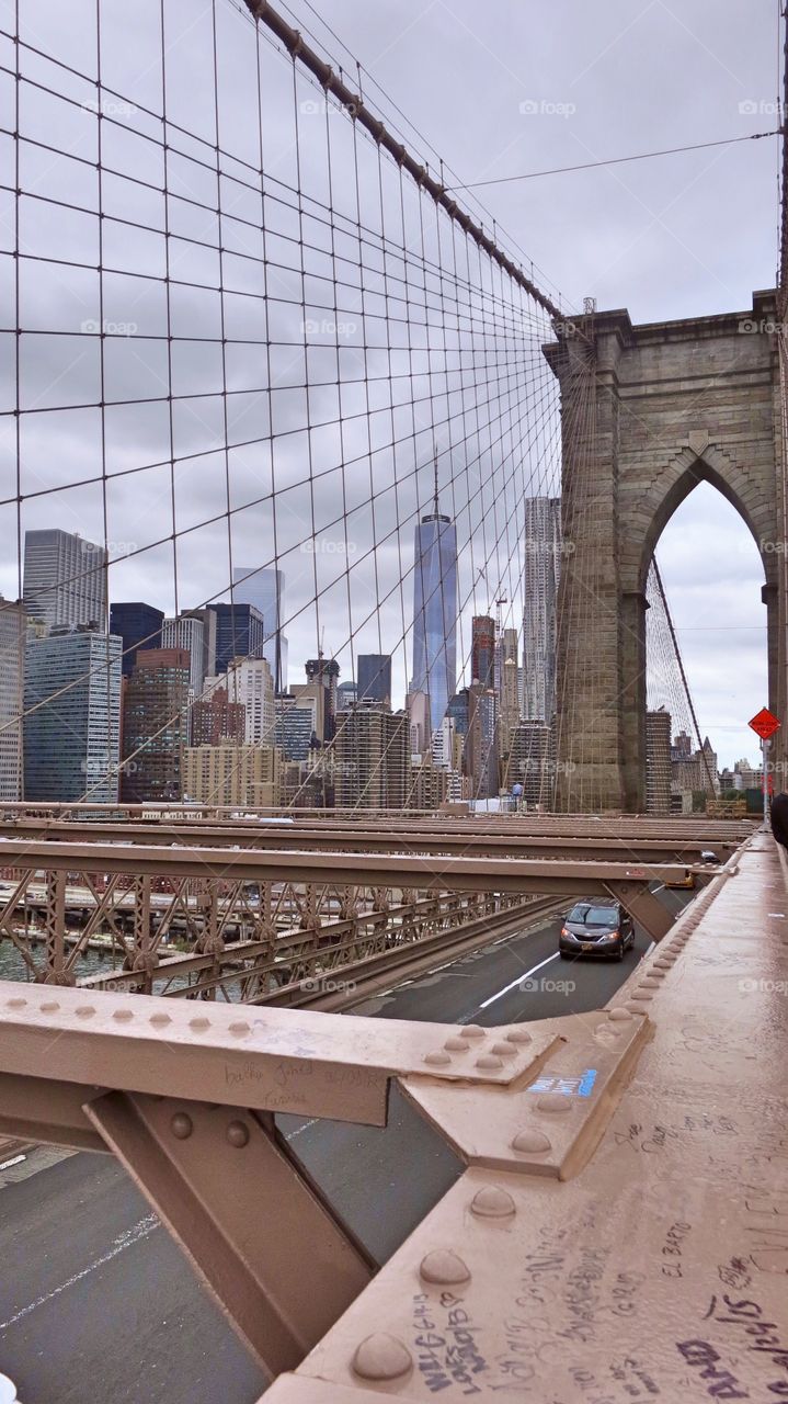 A view of commuters driving below on the the Brooklyn Bridge. 