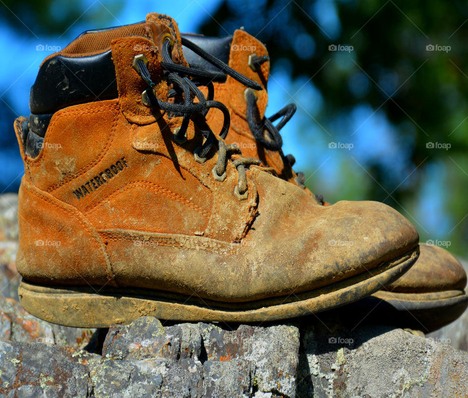 The boots were old. The leather had since cracked and aged. The toes were scuffed and they were falling apart at the seams. The boots had long lived their life of travel,work,joy, and love. After their final journey, it was time to throw them away. It was hard to say GOODBYE!