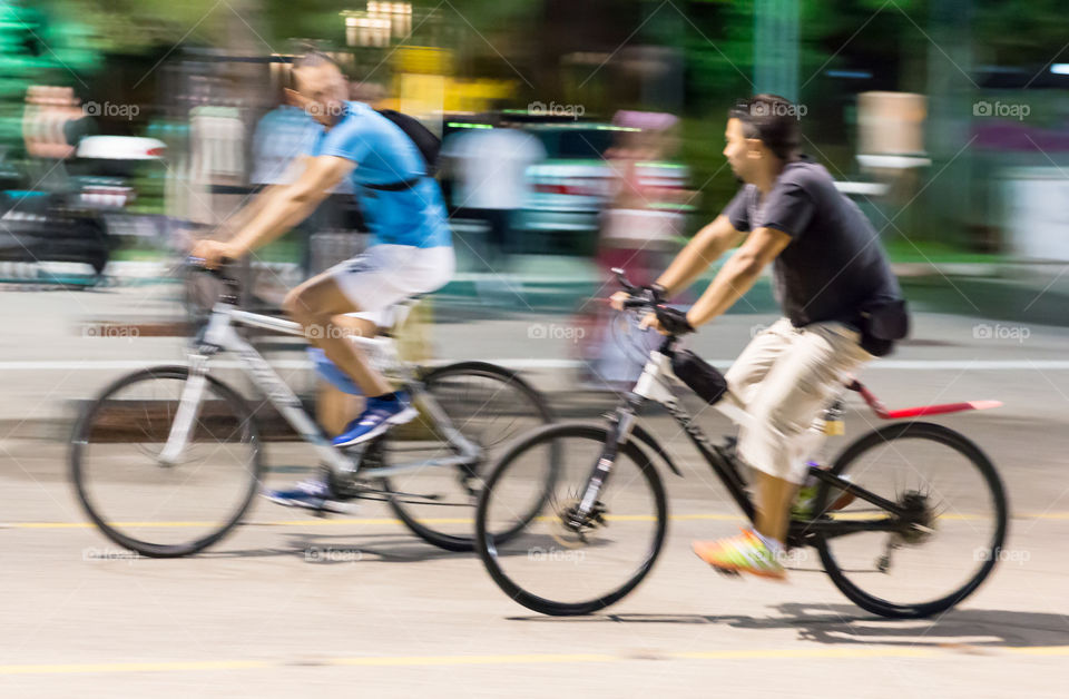 Two Young Men On Bike Ride In The City
