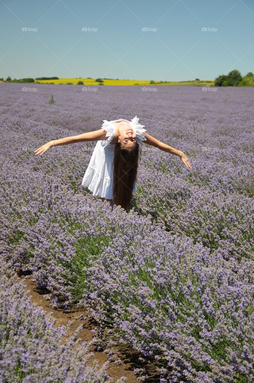 Woman  brunette with beautiful natural hair on lavender fields