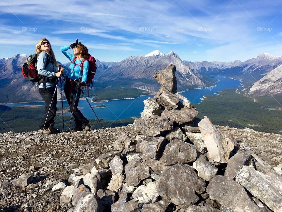 Two woman standing near river