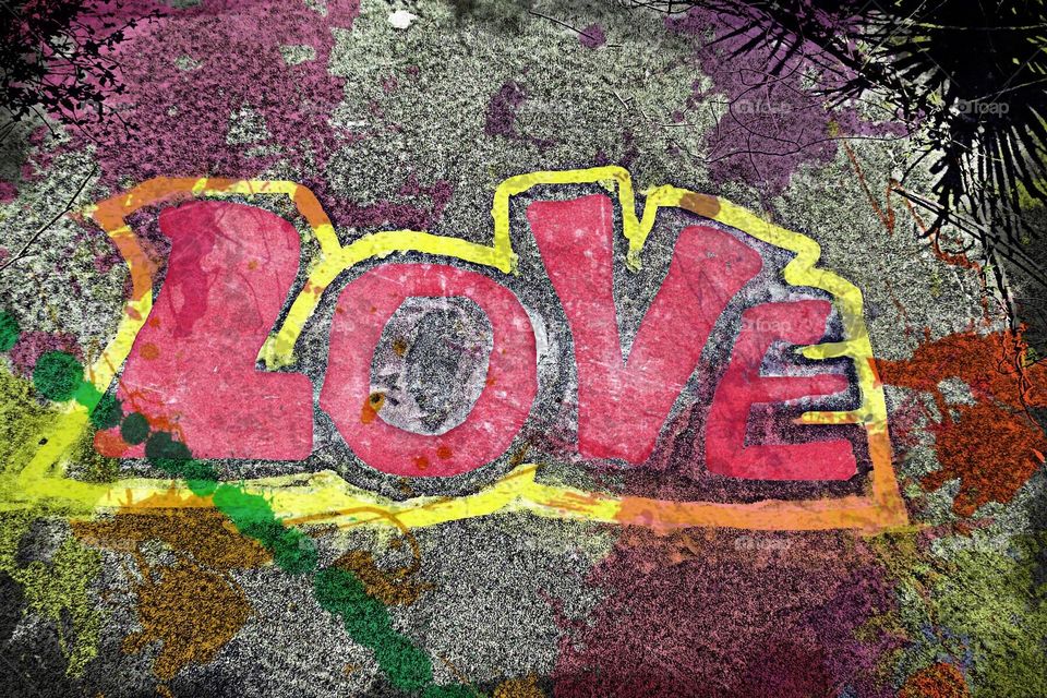 Multicolored graffiti art on cement spelling LOVE.