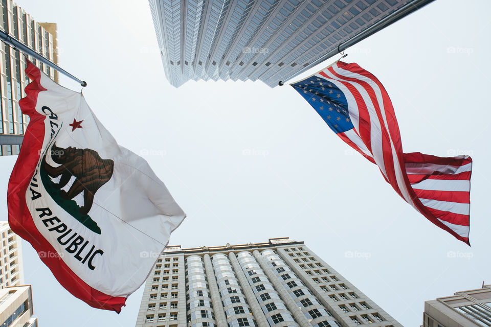 California and USA flags near office buildings in downtown San Francisco 