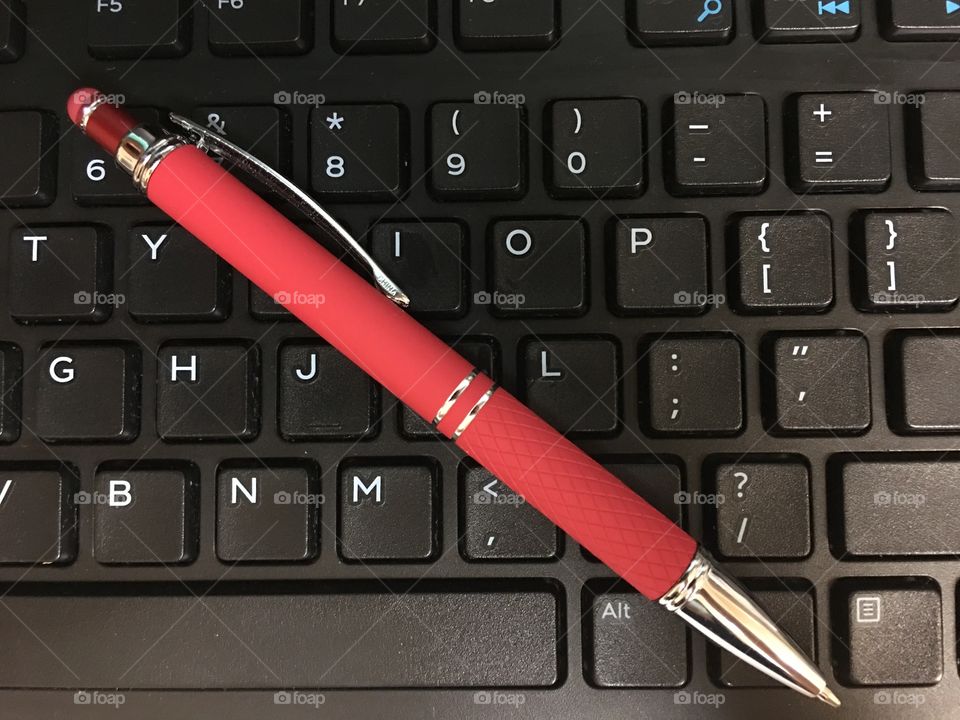 Red pen on keyboard 