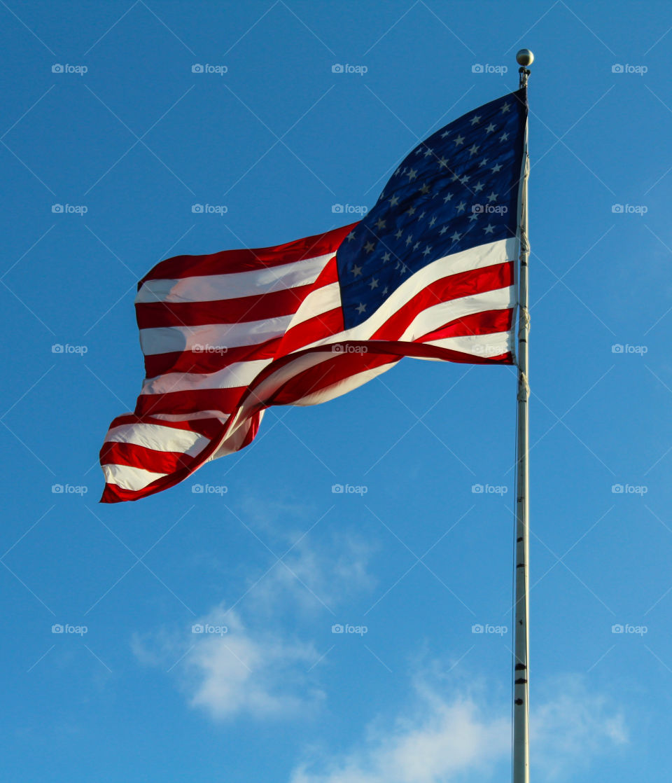 American flag flying over American Legion on a windy day 