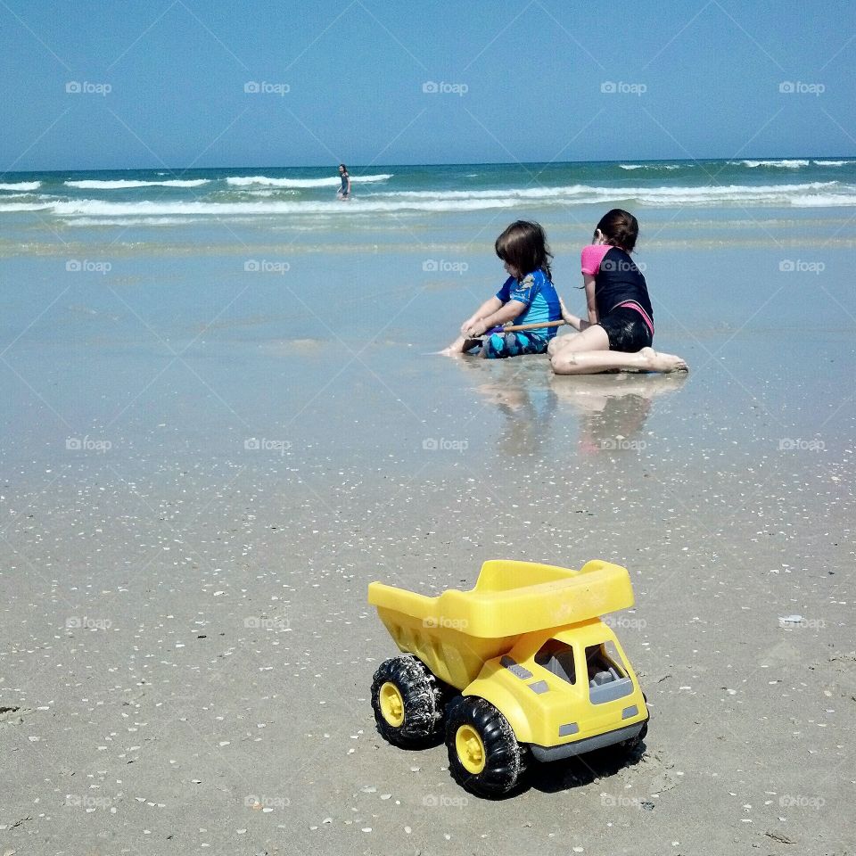 Children Playing on Beach Yellow Truck