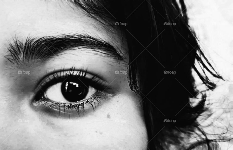 the eye of a woman in black and white photo